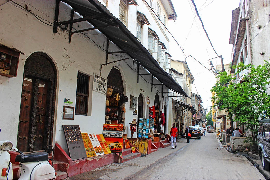 Mombasa Old Town narrow alley with carved wooden doors and Swahili architecture